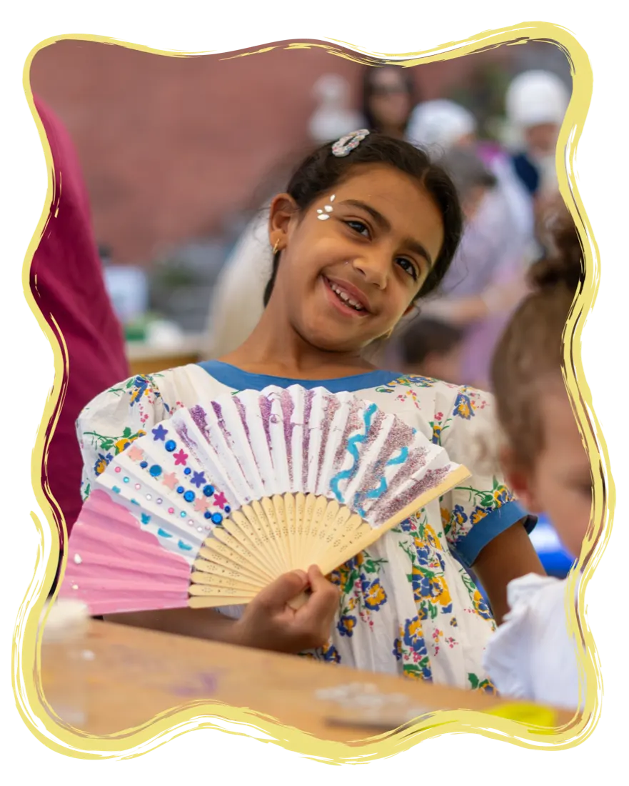 A happy girl with a colorful hand-painted fan
