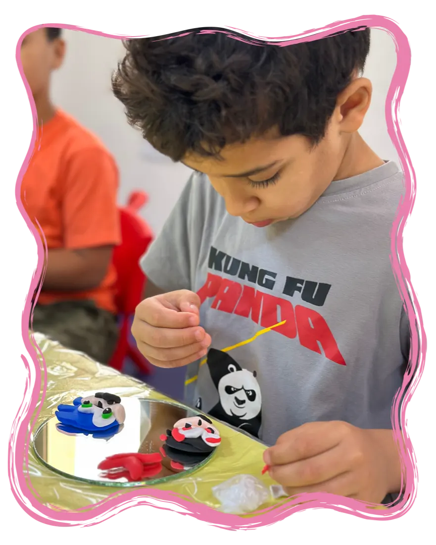 A boy painting a gypsum figurine