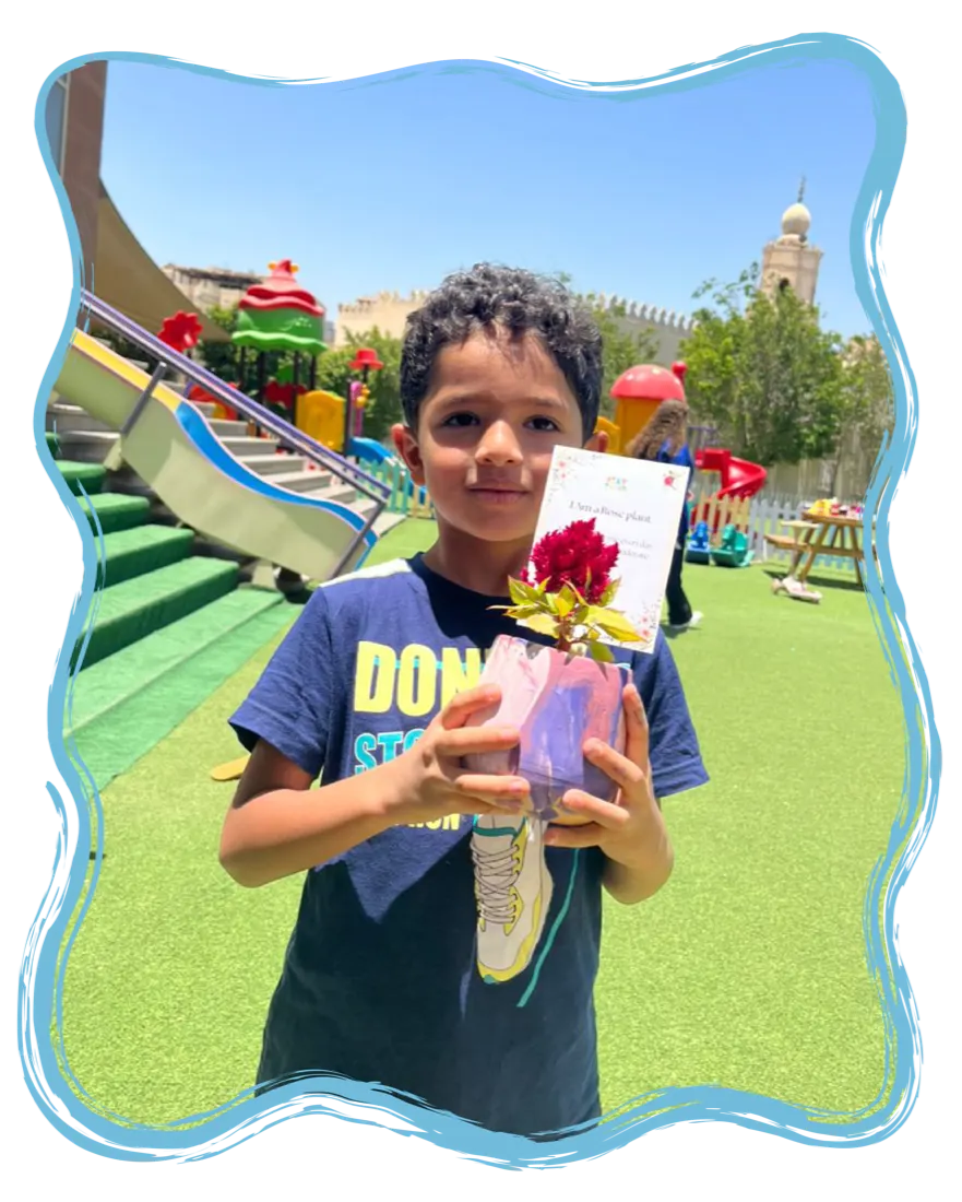 A smiling child celebrating at Playtopia
